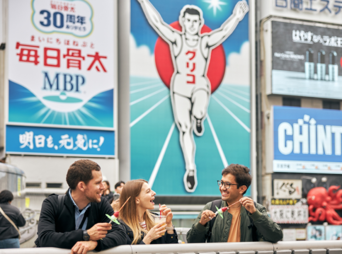 The famous Glico running man sign and other neon lights reflecting in Dotonbori canal