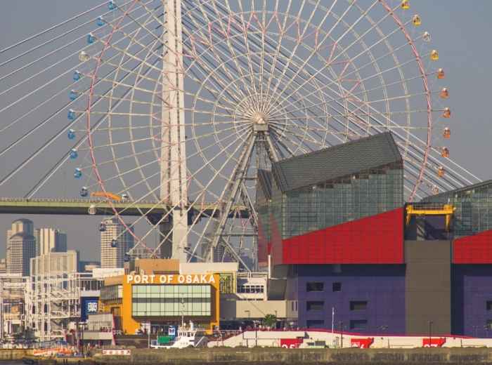Large Ferris wheel at Tempozan Harbor Village with bay and ships visible.