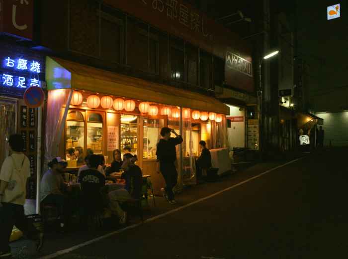 Hip cafe with outdoor seating on tree-lined street Photo by hayato togashi on Unsplash