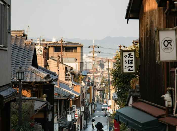 Quiet residential street in Kyoto showing traditional houses and daily life. Photo by Daisy Chen on Unsplash