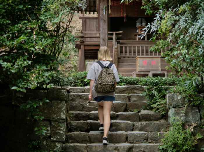Traveler properly prepared with comfortable shoes for temple stair climbing Photo by Serg Magpie on Unsplash