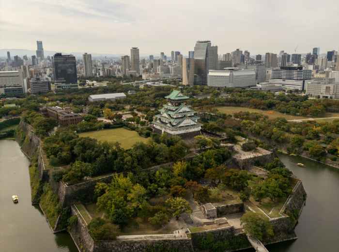 Osaka skyline from above with castle park visible photo by  Clayton Cardinalli  Unsplash
