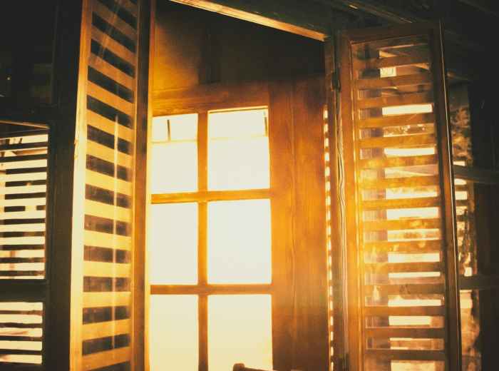 Early morning light filtering through traditional wooden lattice windows in Gion district. Photo by Mahdi Bafande on Unsplash