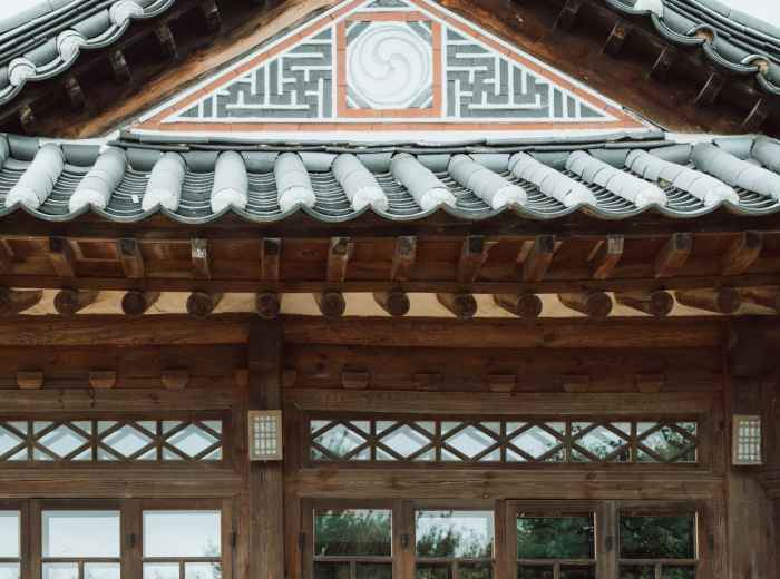 Silver Pavilion's weathered wood exterior with traditional garden elements in foreground Photo by Paul Bill on Unsplash