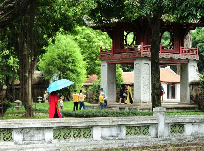 Local residents practicing tai chi in Imperial Park with traditional buildings in background Photo by Ama Journey on Unsplash