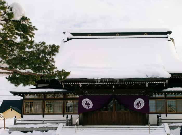 Train station with shrine entrance visible in near distance Photo by Natalie Su on Unsplash