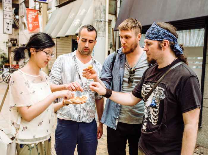 Guests and host enjoying street food.