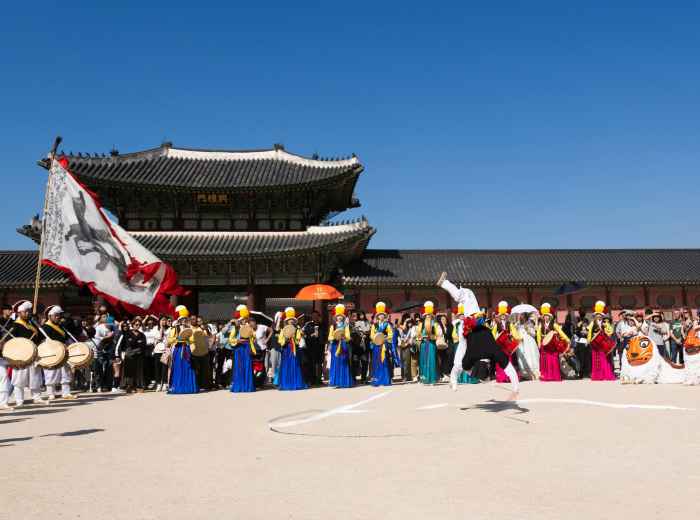 Grand entrance gates of Kyoto Imperial Palace with festival participants in colorful historical costumes gathering in the courtyard. Image by Shibin Joseph from Unsplash