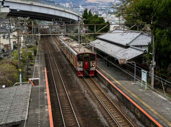 Traditional train station platform with autumn mountain views in background. Image by Kouji Tsuru from Unsplash