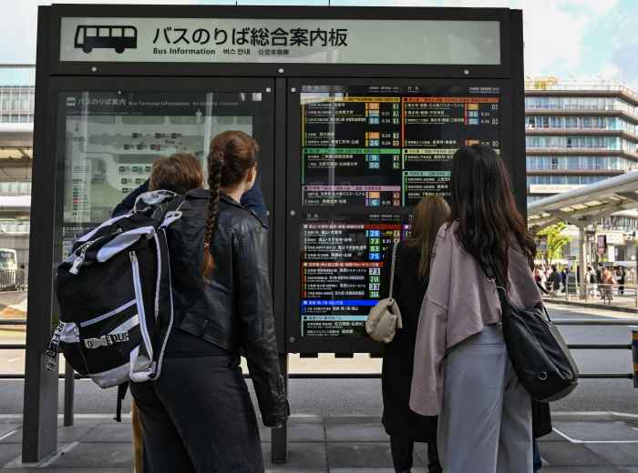 Tourists walking through Kyoto.