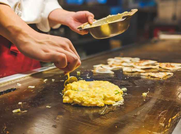 Chef preparing okonomiyaki  Photo by Daniel Hooper 
