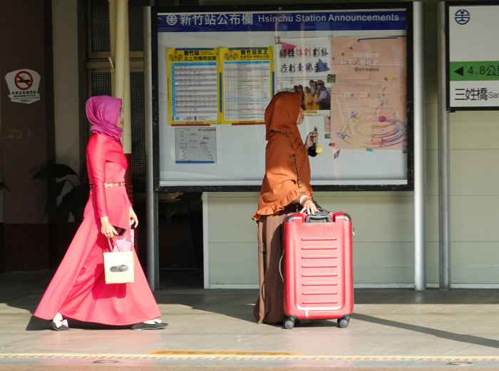 Travelers with light luggage walking past map at Shin-Osaka Photo by Arthur Tseng on Unsplash