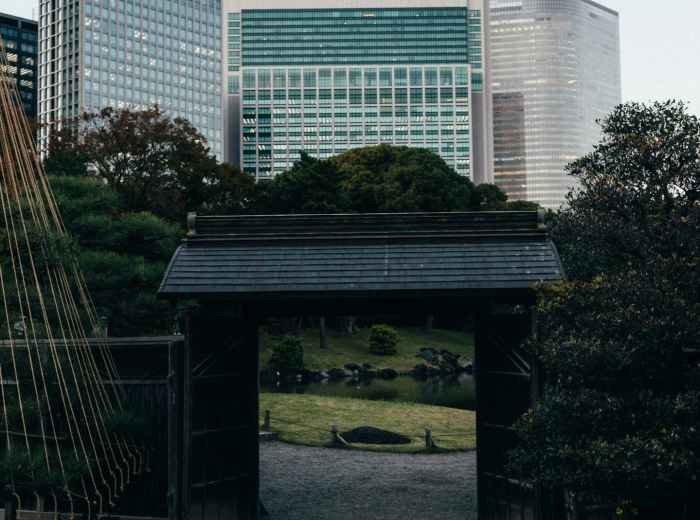 Traditional wooden structure against modern skyline Photo by Tsuyoshi Kozu on Unsplash