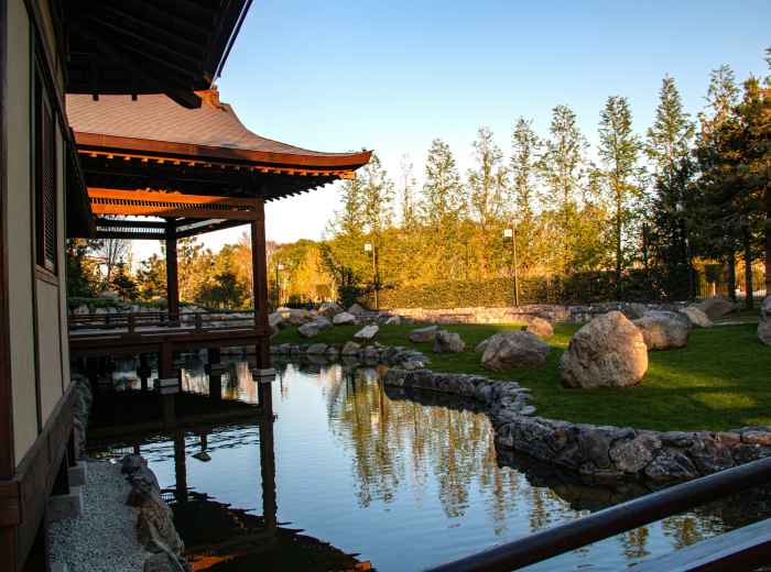 Traveler relaxing in outdoor hot springs with sunset view Photo by Stepan Konev on Unsplash