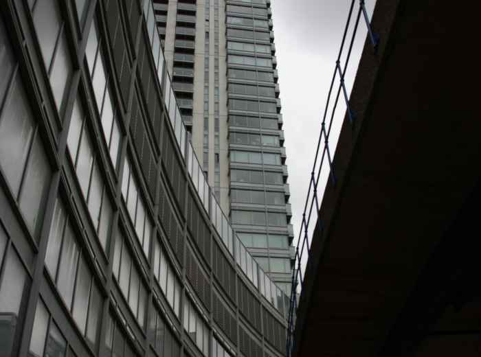 Looking up at modern Osaka skyscraper from street level perspective Photo by Randy Bailey on Unsplash