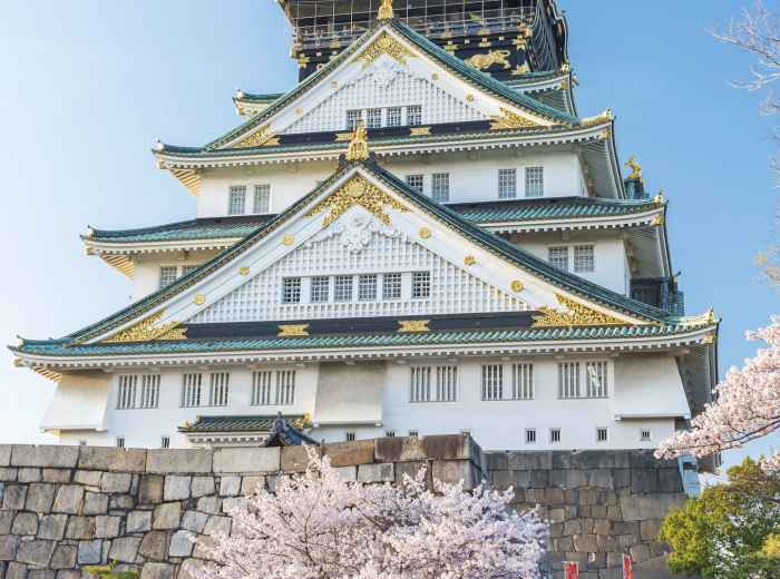 Families visiting Osaka Castle during cherry blossom season