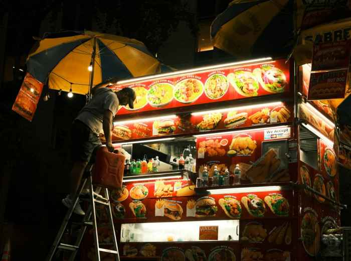A night vendor packing up after a long evening Photo by Hugo Breyer on Unsplash