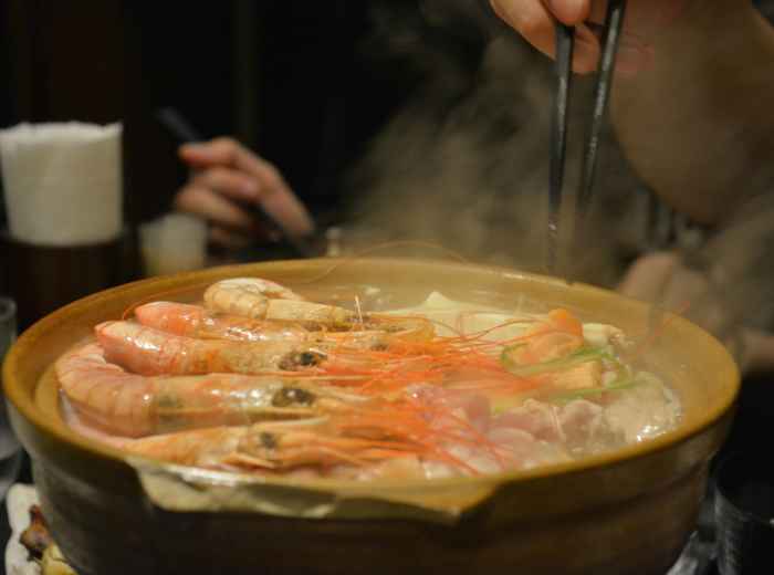 Traditional warm winter foods being enjoyed by locals in cozy restaurant setting Photo by Jerry Shen on Unsplash