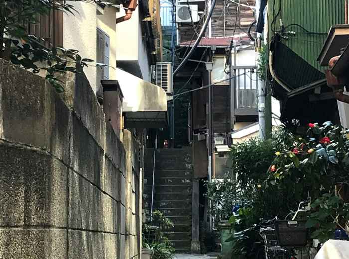 A quiet morning scene in a residential Osaka neighborhood with locals going about their daily routines Photo by YUGO ASAI on Unsplash