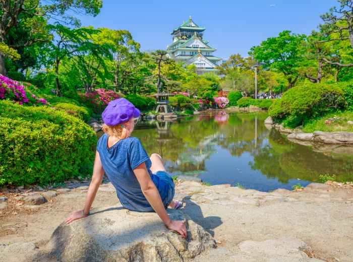 A peaceful morning scene at Osaka Castle grounds with soft light and minimal crowds.