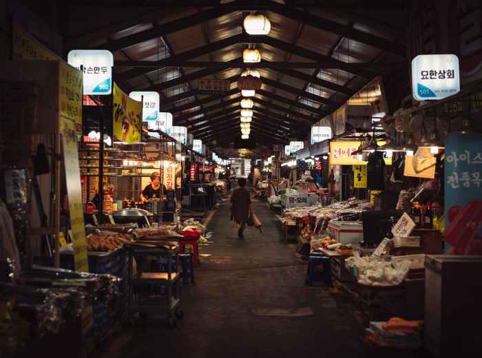 Colorful morning market scene with fresh ingredients and bustling vendors. Photo by rawkkim on Unsplash