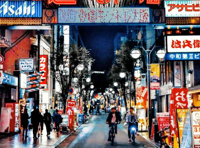 Crowded summer festival street in Dotonbori with food stalls Photo by Haugenzhays Zhang on pexels