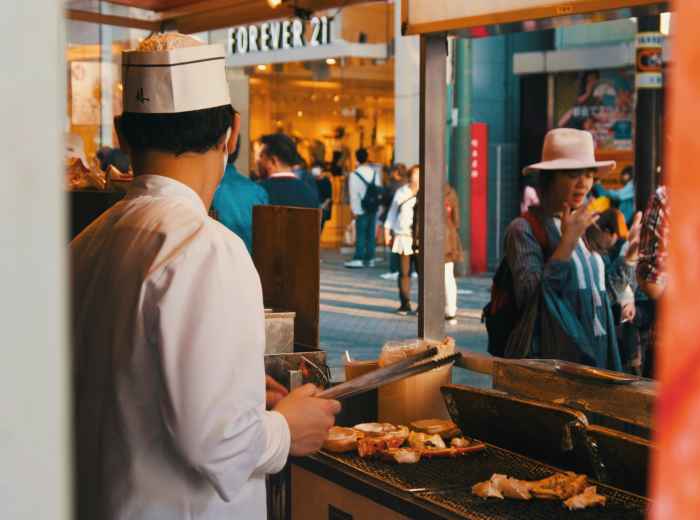  A street food vendor preparing hot food near Osaka Station, with commuters stopping for quick warming meals Photo by Nomadic Julien on Unsplash