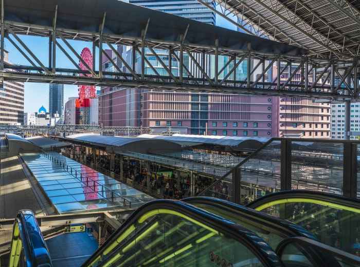 Osaka Station's main concourse during morning rush hour with streams of commuters. Image by 