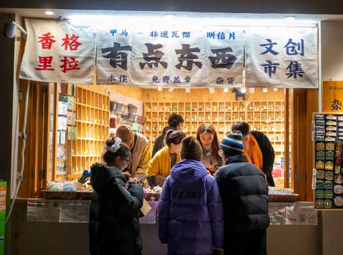 Traditional sweet shop vendor offering samples to interested customers Photo by leoon liang on Unsplash