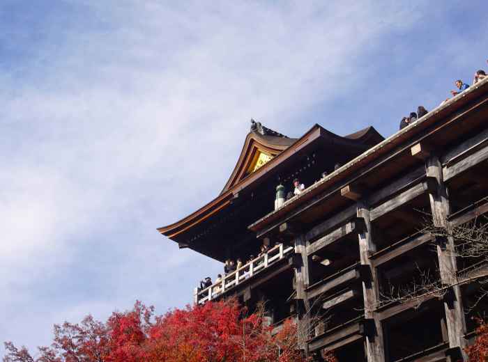 Traditional temple architecture silhouetted against autumn sky Photo by Syadza Salsabyla on Unsplash