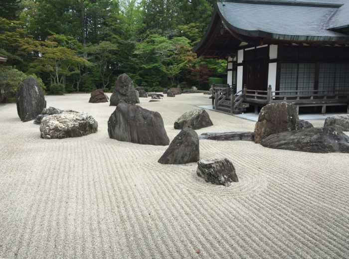 The famous rock garden at Ryoan-ji temple with 15 stones arranged in raked gravel Photo by Ray Wyman Jr on Unsplash
