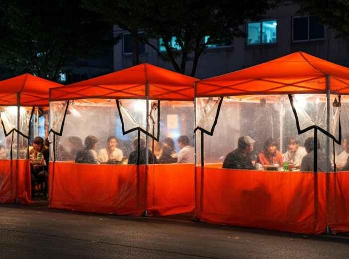 Traditional pocha tent bar with warm lighting and customers inside