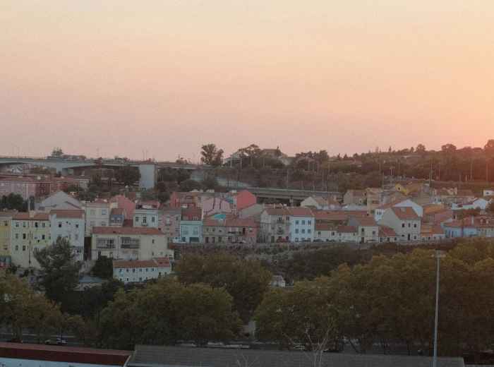 Sunset panorama from Miradouro da Senhora do Monte across Lisbon’s skyline