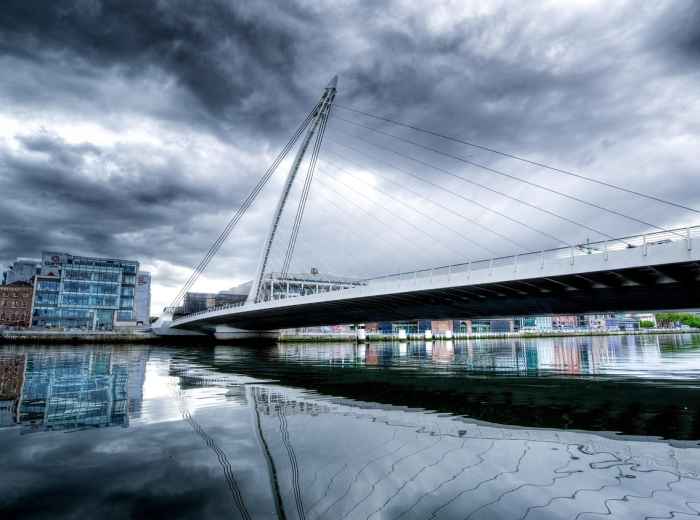 Samuel Beckett Bridge over the River Liffey with Dublin Docklands skyline