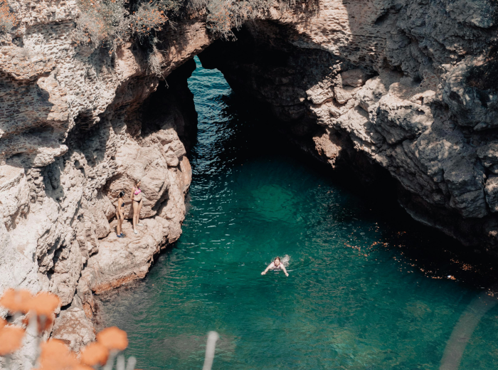 Sunlit natural pool among by the sea