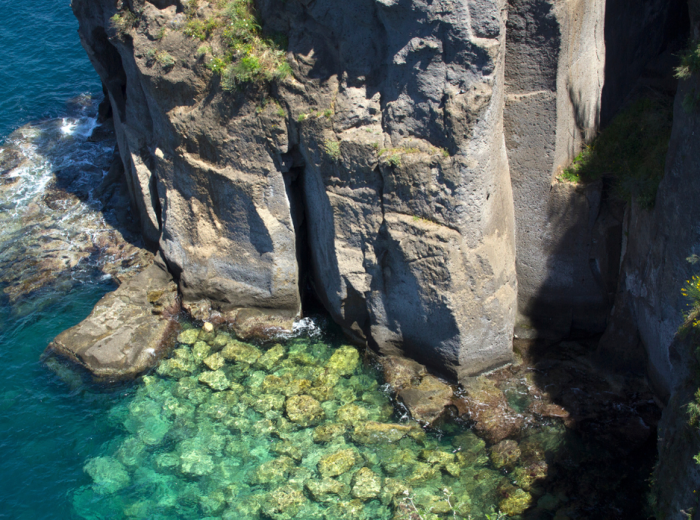 Crystal clear turquoise water surrounded by dramatic rocky cliffs