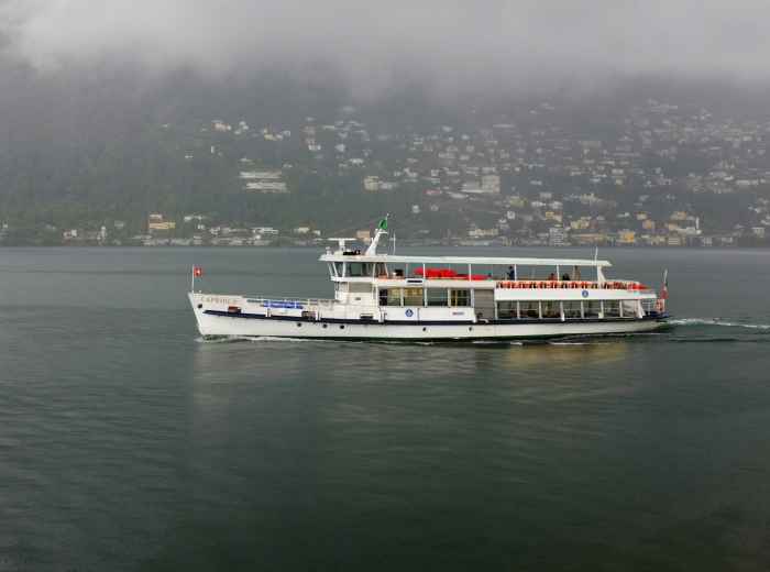 First ferry on Lake Como with soft light at 7 AM today