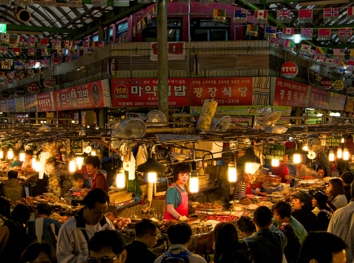 Night scene at Gwangjang Market with vendors working hard 