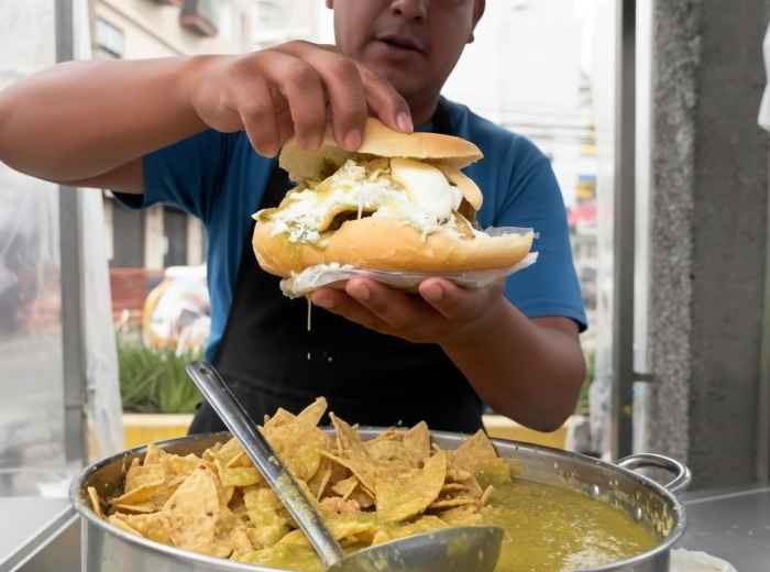Guajolota - bolillo roll stuffed with a tamal and chilaquiles