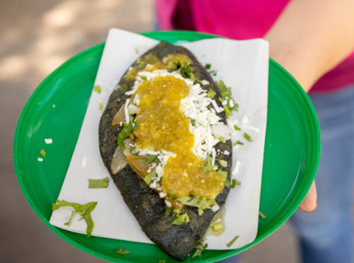 Blue maize tlacoyo with green salsa