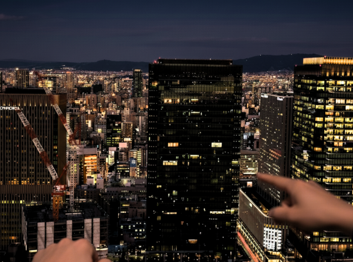City lights spreading to the horizon from the Kuchu Teien Observatory rooftop