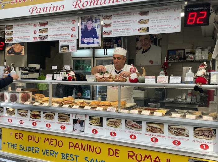 Vendor slicing panini at Mordi e Vai in Mercato Testaccio