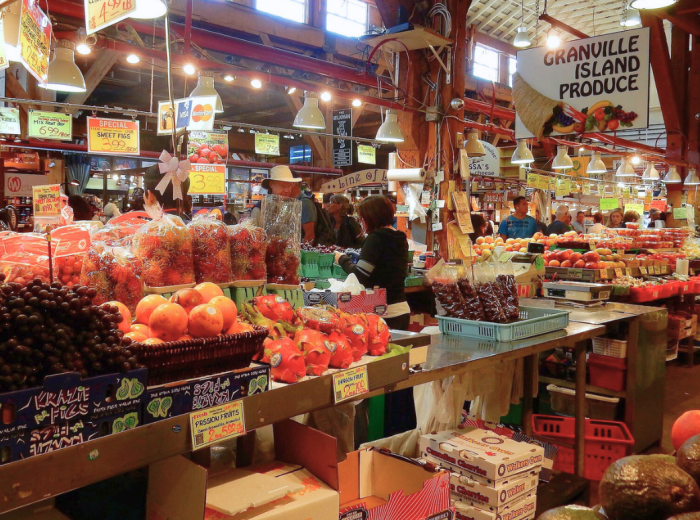 Granville Island market produce stall with seasonal fruit and veg