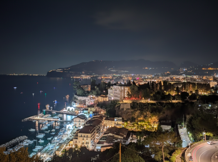 Clifftop hotel terrace overlooking lights across the bay