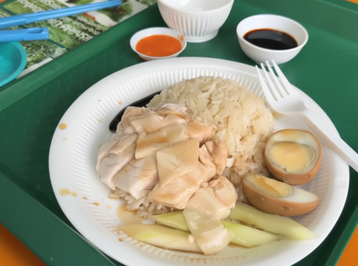 Delicious plate of chicken rice served with dark soy sauce
