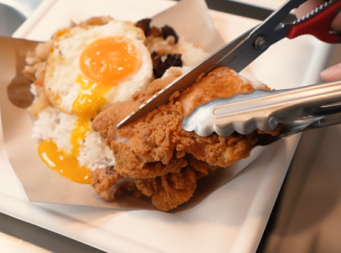Curry rice being prepared with scissors at Beach Road