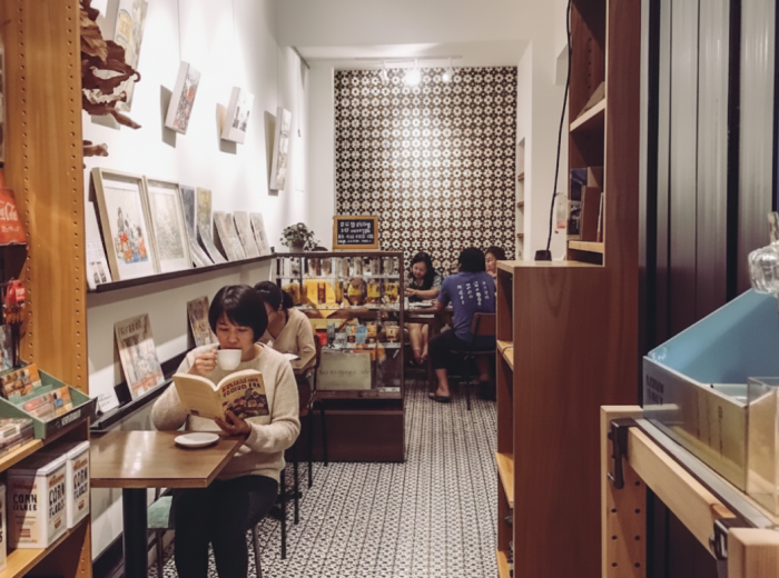 Drinking coffee and reading a book at Grassroots Book Room