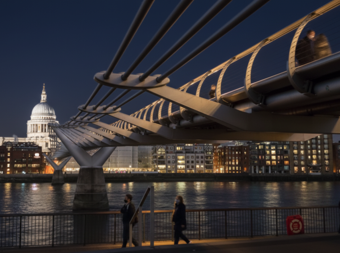 Quiet Millennium bridge with city light reflecting in the Thames