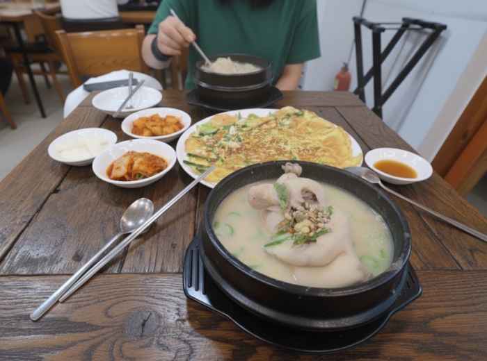 Clay bowl of samgyetang with ginseng, dates, and rice