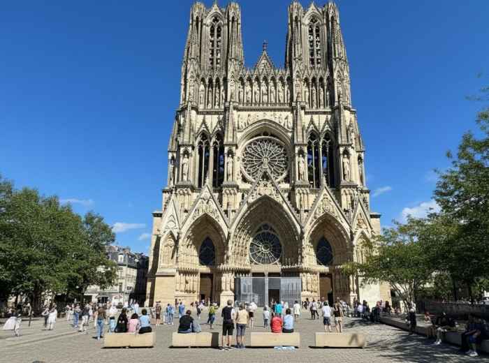 Reims Cathedral's Gothic facade with an intricate rose window and sculptures